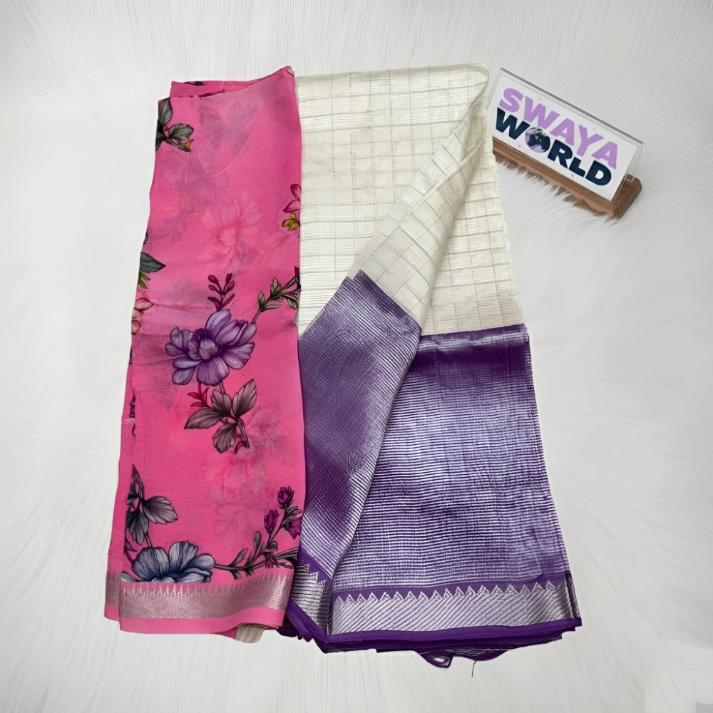Two folded sarees, one pink with floral patterns and the other purple with a striped pattern, on a white surface with 'Swaya World' branding.