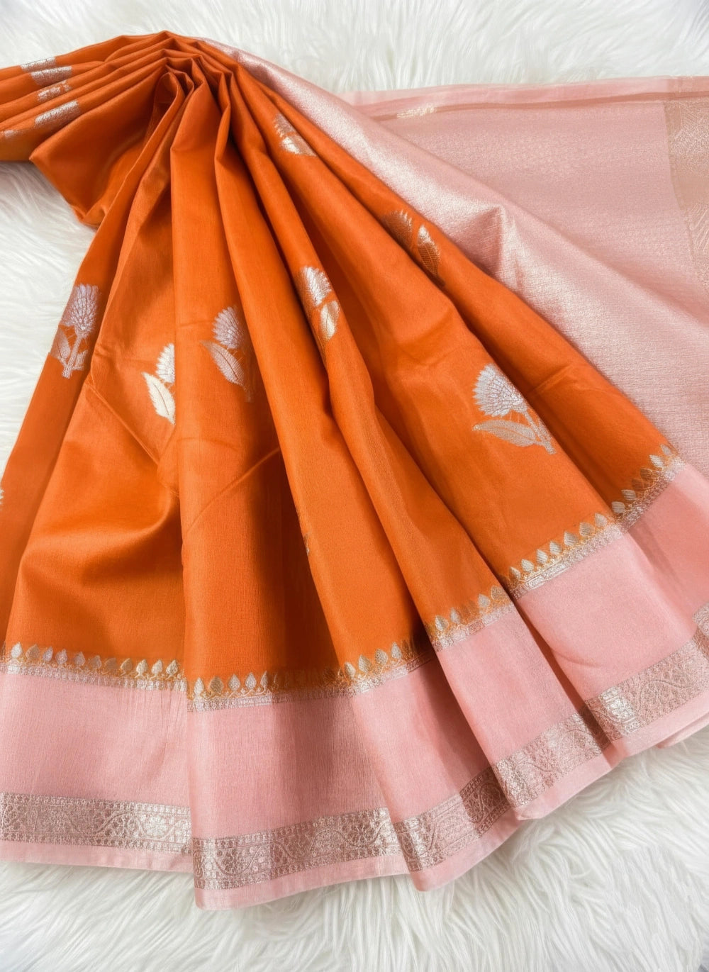 Orange and pink saree with a white background