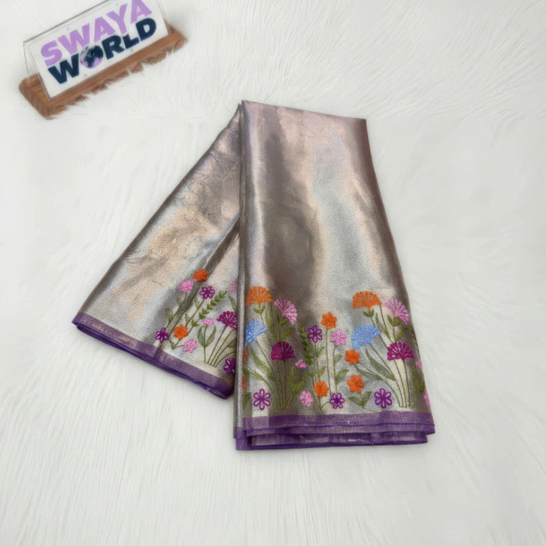 Gray/silver Saree with floral patterns on a white background, featuring 'Swaya World' branding.