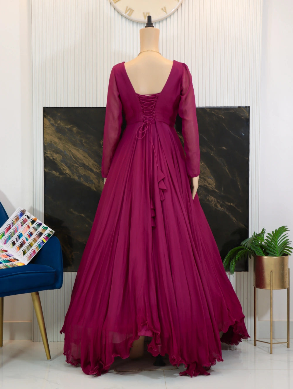 Back view of Magenta georgette long frock with sheer sleeves, fitted bodice, and full flared skirt.