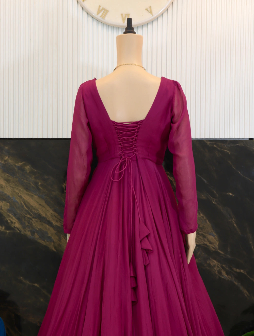 Close back view of Magenta georgette long frock with sheer sleeves, fitted bodice, and full flared skirt.