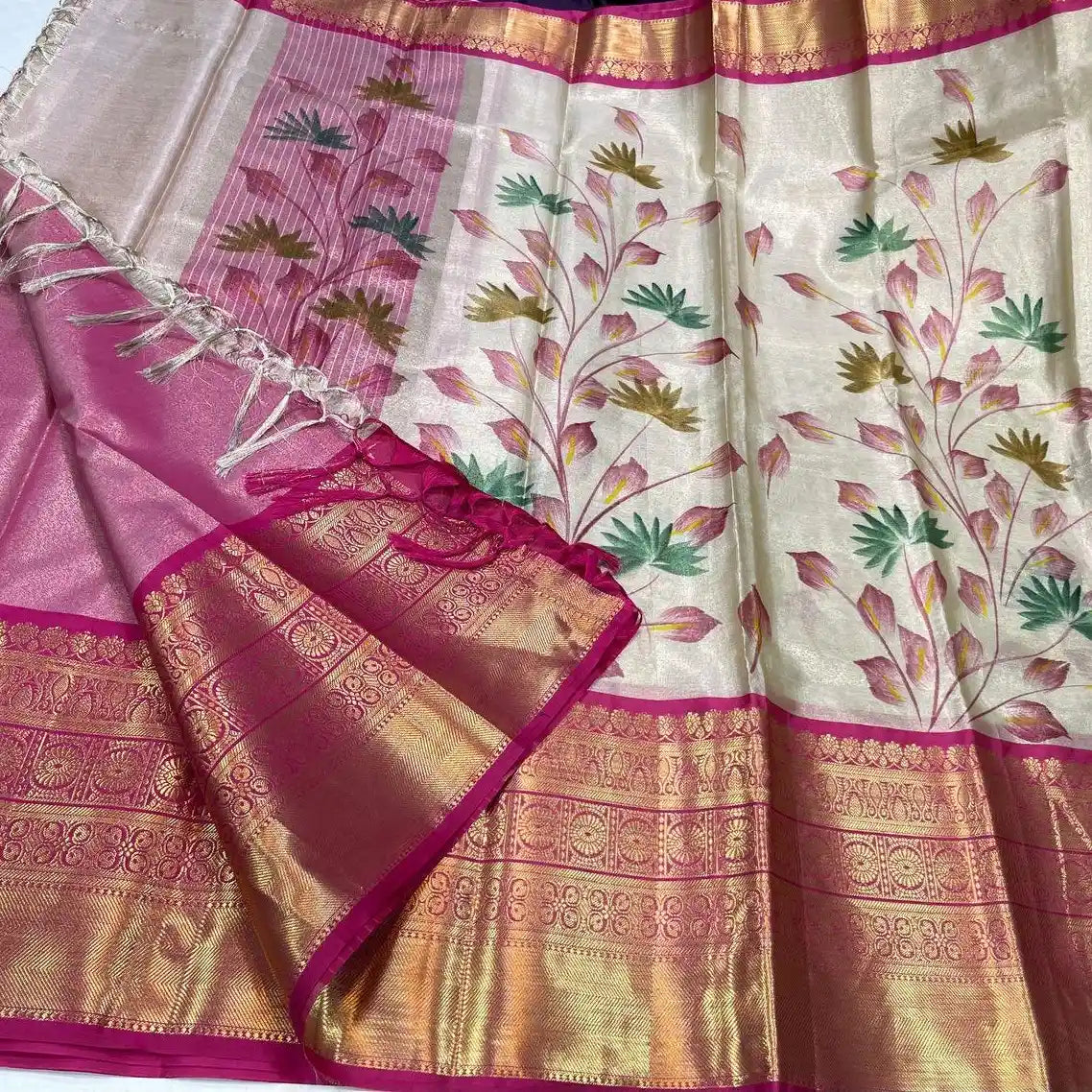 Traditional saree with pink and gold border and floral patterns on a white background