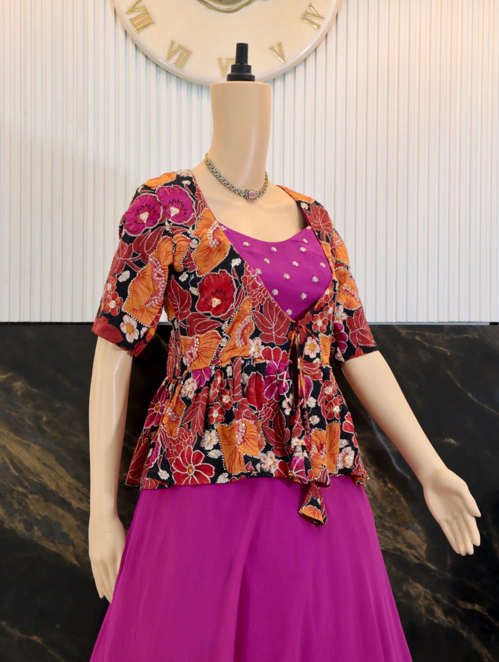 Close side angle of pink georgette gown with butti work and multicolor autumn tapestry peplum coat
